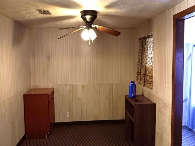 hallway with a textured ceiling