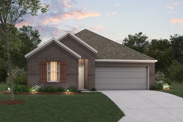 view of front facade with a garage and a yard