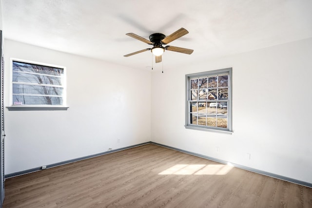 empty room featuring hardwood / wood-style flooring and ceiling fan