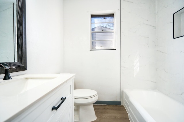 full bathroom featuring hardwood / wood-style flooring, vanity, toilet, and tiled shower / bath combo