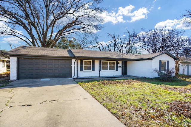 ranch-style home with a garage and a front lawn