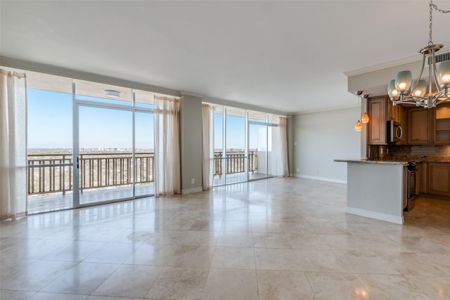 unfurnished living room featuring expansive windows, crown molding, light tile patterned floors, and a notable chandelier