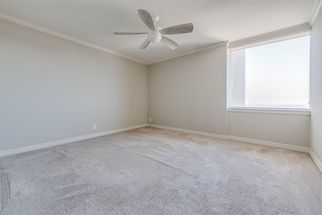 empty room with carpet floors, ornamental molding, and ceiling fan