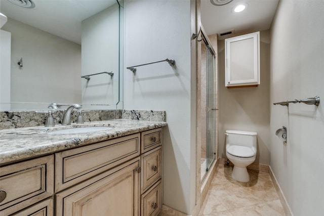 bathroom featuring tile patterned flooring, vanity, walk in shower, and toilet