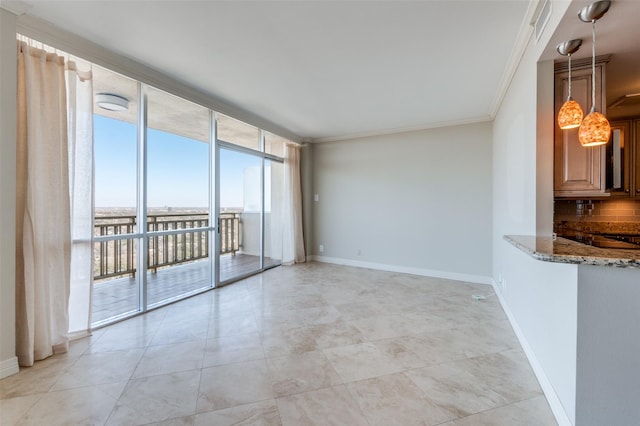 empty room with light tile patterned flooring, a wall of windows, and ornamental molding