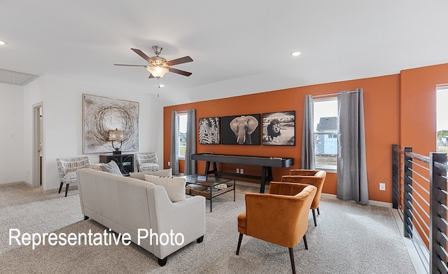 living room with ceiling fan, a healthy amount of sunlight, and light carpet