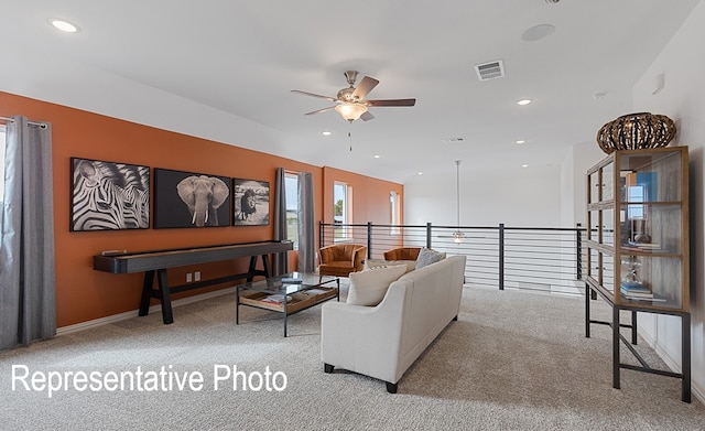 living room with ceiling fan and light carpet