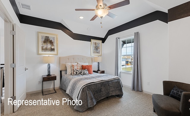 carpeted bedroom with ceiling fan and vaulted ceiling