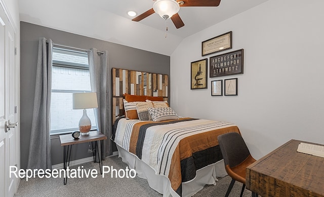 carpeted bedroom featuring lofted ceiling and ceiling fan