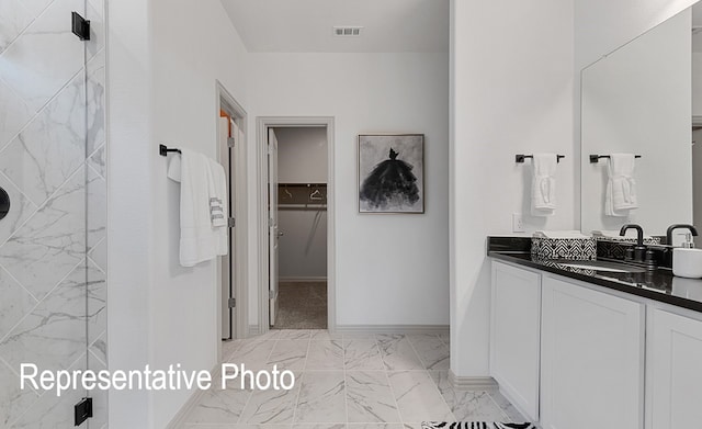 bathroom featuring vanity and a shower