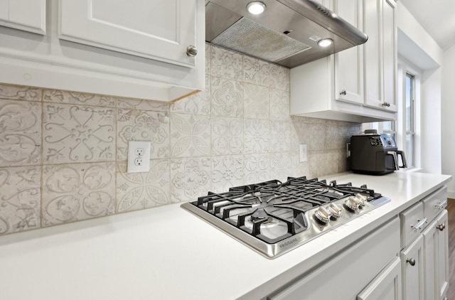 kitchen with white cabinetry, stainless steel gas cooktop, and range hood