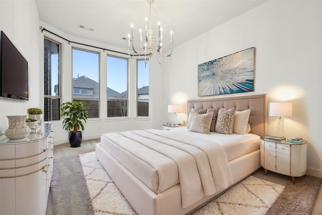 bedroom featuring a notable chandelier