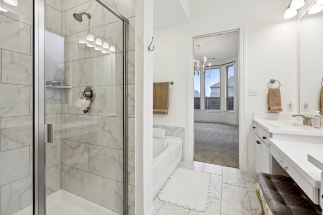 bathroom featuring vanity, independent shower and bath, and a notable chandelier