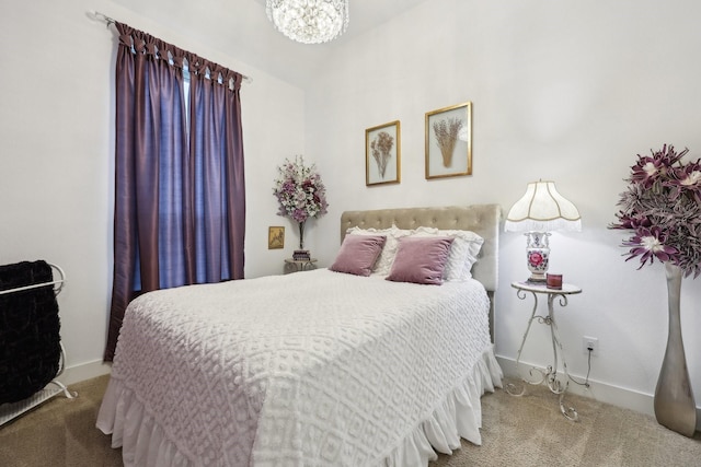 bedroom featuring an inviting chandelier and carpet flooring