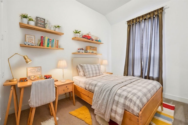 bedroom with lofted ceiling and carpet floors