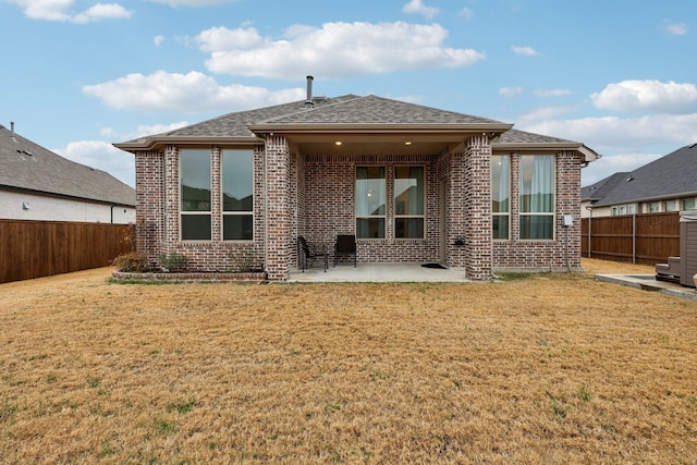 rear view of property with a patio area and a lawn