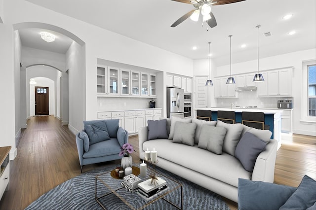 living room with hardwood / wood-style floors and ceiling fan