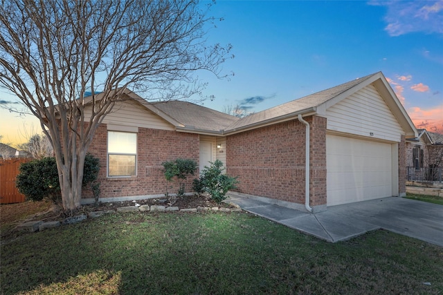 single story home with a garage and a lawn