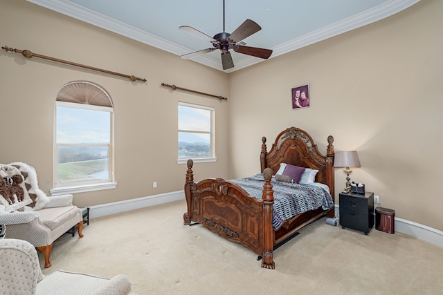 carpeted bedroom featuring baseboards, a ceiling fan, and crown molding