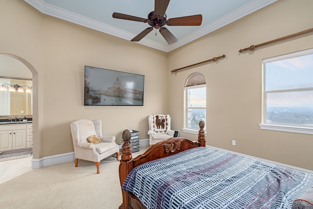 bedroom featuring ornamental molding, arched walkways, light carpet, and baseboards