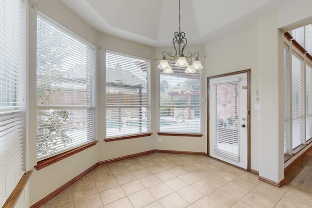 unfurnished dining area featuring a healthy amount of sunlight, light tile patterned floors, and a notable chandelier