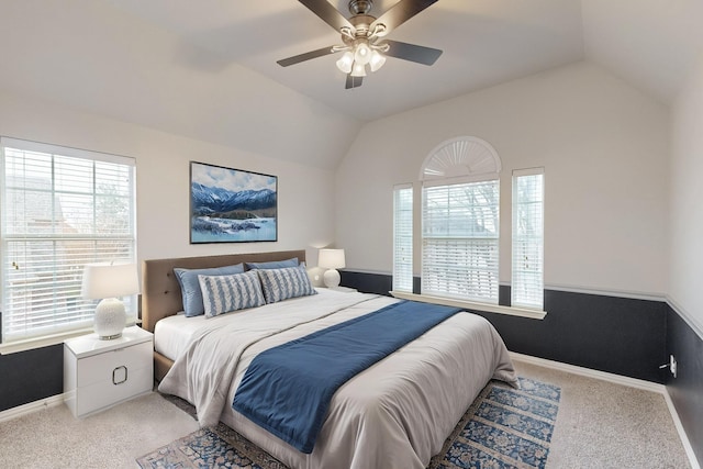 carpeted bedroom featuring ceiling fan and vaulted ceiling