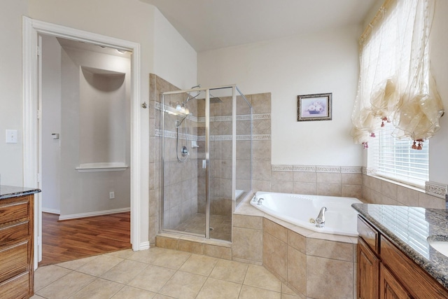 bathroom with vanity, tile patterned floors, and shower with separate bathtub