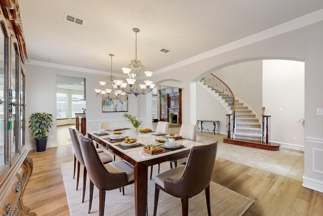 dining room featuring ornamental molding and light hardwood / wood-style flooring