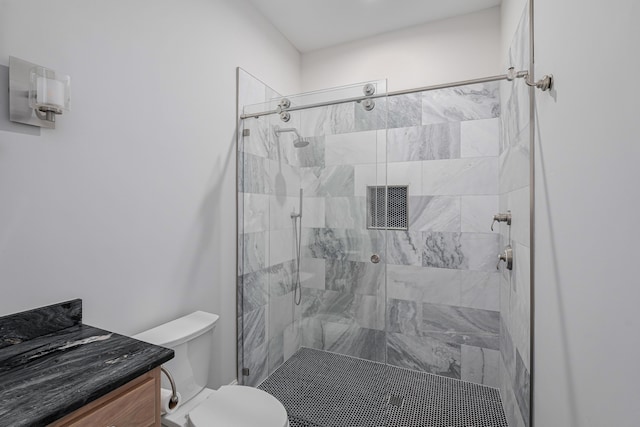 bathroom featuring vanity, toilet, and walk in shower