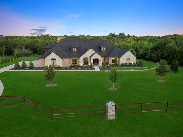 french country home with a lawn