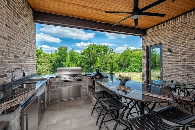 view of patio / terrace featuring exterior kitchen, area for grilling, sink, and ceiling fan