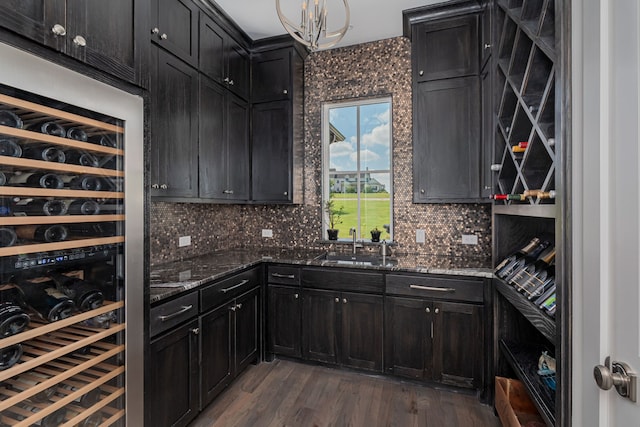 wine room featuring wine cooler, dark hardwood / wood-style floors, and sink