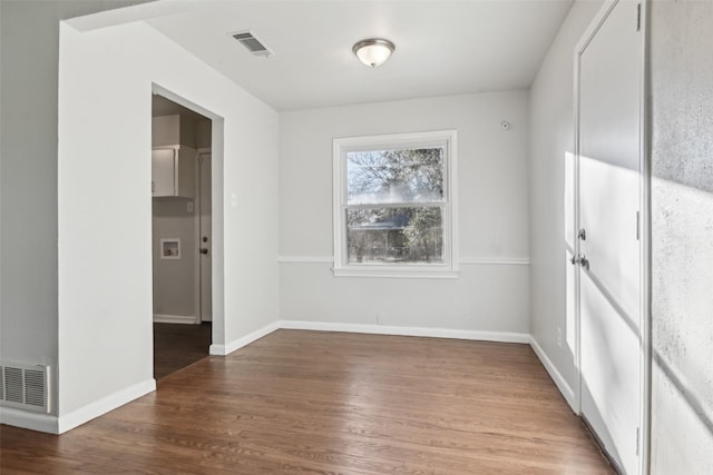 unfurnished room featuring hardwood / wood-style flooring