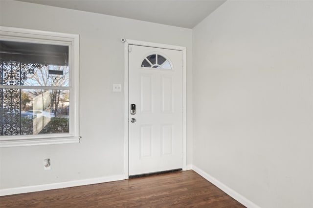 entryway with dark hardwood / wood-style flooring