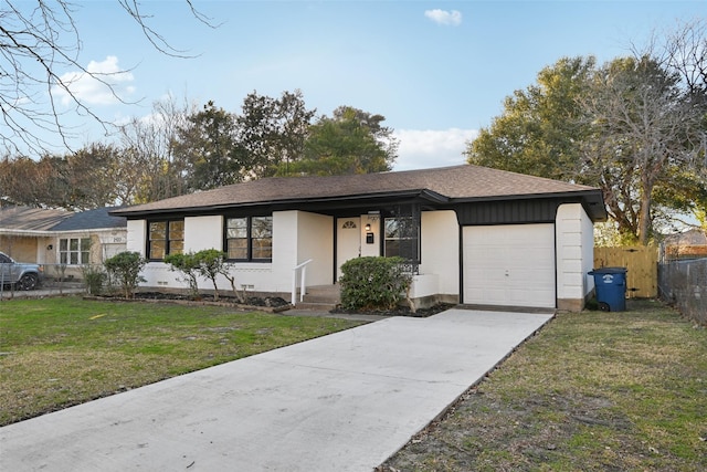 single story home featuring a garage and a front yard