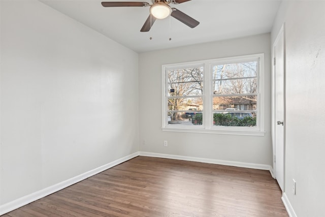 spare room featuring dark hardwood / wood-style floors and ceiling fan