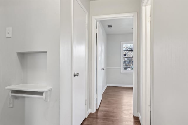 corridor featuring dark hardwood / wood-style floors