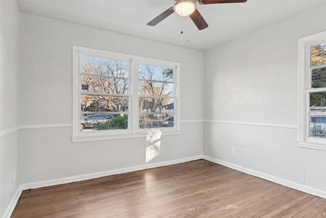 unfurnished room with hardwood / wood-style floors and ceiling fan