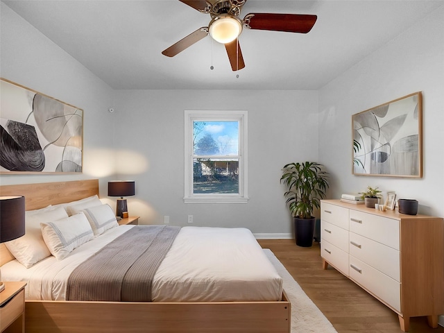 bedroom featuring light hardwood / wood-style floors and ceiling fan