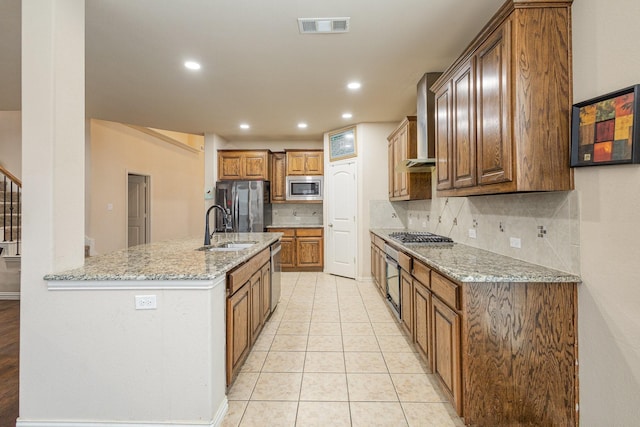 kitchen featuring sink, light tile patterned floors, stainless steel appliances, light stone countertops, and decorative backsplash