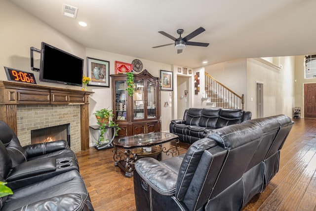 living room featuring hardwood / wood-style flooring, a fireplace, and ceiling fan