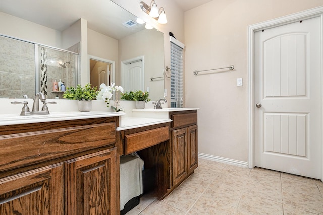 bathroom featuring walk in shower, vanity, and tile patterned flooring