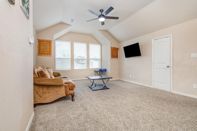 living area featuring lofted ceiling, carpet floors, and ceiling fan