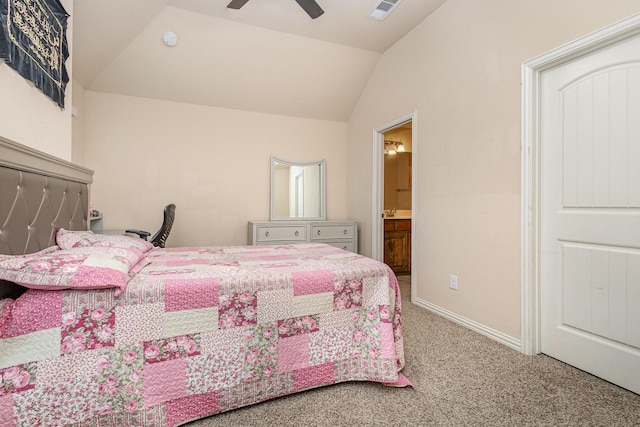 carpeted bedroom with ceiling fan, lofted ceiling, and ensuite bathroom