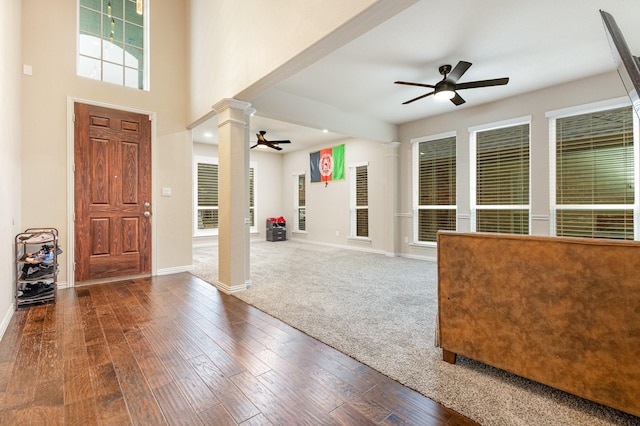 entryway featuring ceiling fan, dark hardwood / wood-style floors, and ornate columns