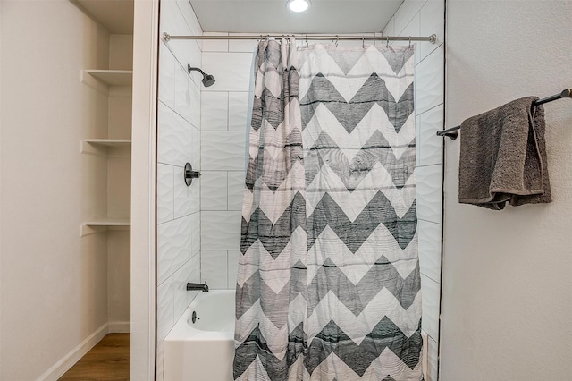 bathroom featuring wood-type flooring and shower / bath combo with shower curtain