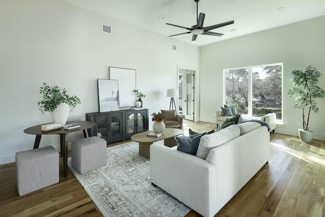 living room with hardwood / wood-style flooring and ceiling fan