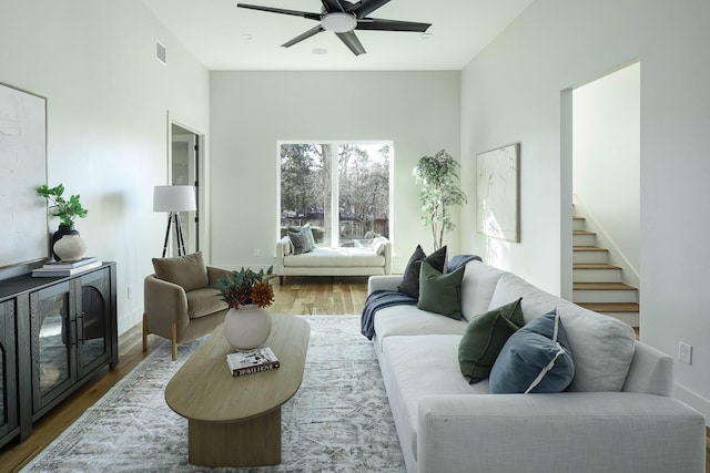 living room featuring ceiling fan and wood-type flooring