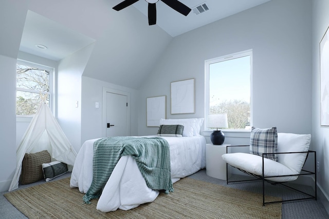 carpeted bedroom featuring multiple windows, vaulted ceiling, and ceiling fan