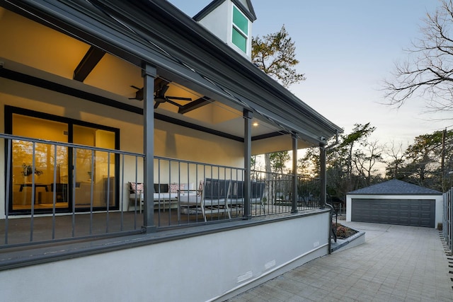 property exterior at dusk with a garage and an outdoor structure